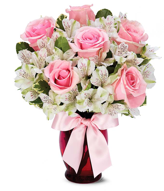 Pink roses and white alstroemeria in a pink vase