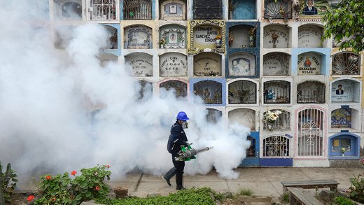 A specialist fumigates Peru’s largest cemetery to prevent the spread of the Chikunguya and Zika viruses.