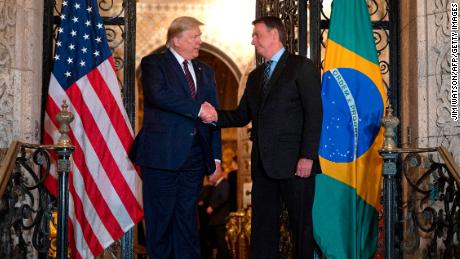 US President Donald Trump (L) shakes hands with Brazilian President Jair Bolsonaro during a diner at Mar-a-Lago in Palm Beach, Florida, on March 7, 2020. (Photo by JIM WATSON / AFP) (Photo by JIM WATSON/AFP via Getty Images)