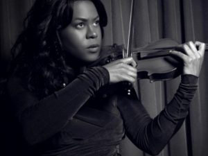 Tona Brown playing the violin from the GLAAD website