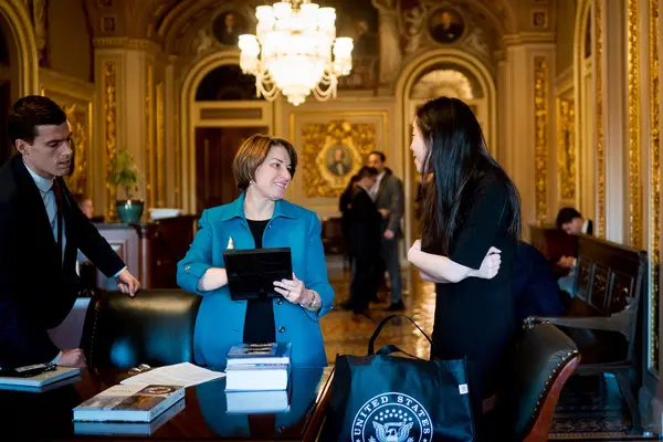 Senator Amy Klobuchar talked with aides at the Capitol in December. For years, she has had among the highest rates of staff turnover in the Senate.