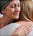 woman with cancer hugging friend
