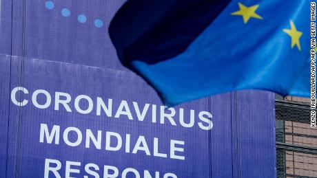 An European Union (EU) flag flutters in front of a newly hung banner that reads &quot;Coronavirus Global Response&quot; in front of The EU Commission building in Brussels, on May 6, 2020. - The EU forecast on May 5, 2020,  that the eurozone economy would contract by a staggering 7.7 percent in 2020, warning the wreckage from the coronavirus outbreak could endanger the single currency. Calling it a &quot;recession of historic proportions&quot;, the EU executive said the 19-member single currency zone would rebound by 6.3 percent in 2021, but in a recovery that would be felt unevenly across the continent. (Photo by Kenzo TRIBOUILLARD / AFP) (Photo by KENZO TRIBOUILLARD/AFP via Getty Images)