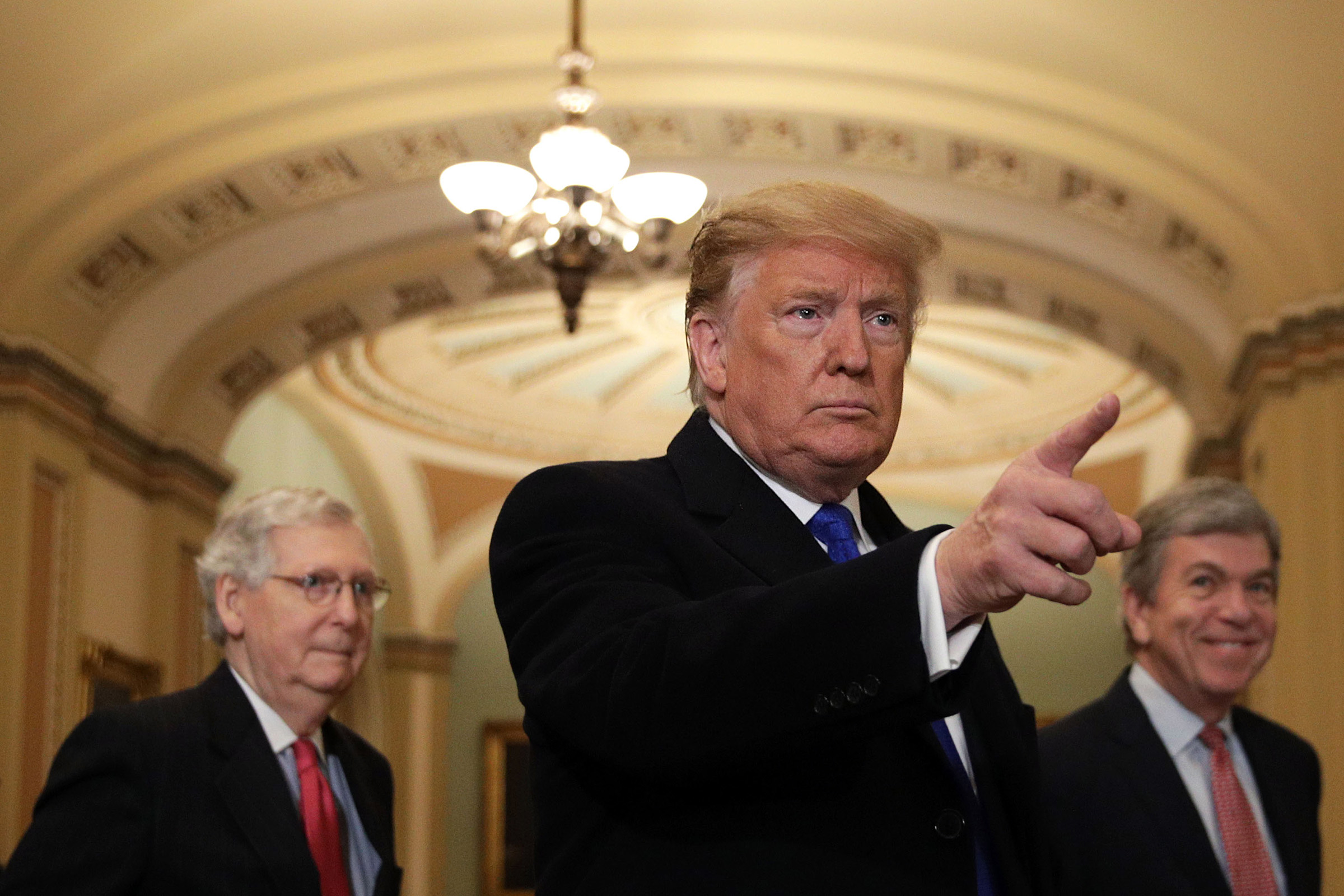 U.S. President Donald Trump (C) speaks to members of the media as Senate Majority Leader Sen. Mitch McConnell (R-KY) (L), and Sen. Roy Blunt (R-MO) (R) look on at the U.S. Capitol in Washington, DC on March 26, 2019.