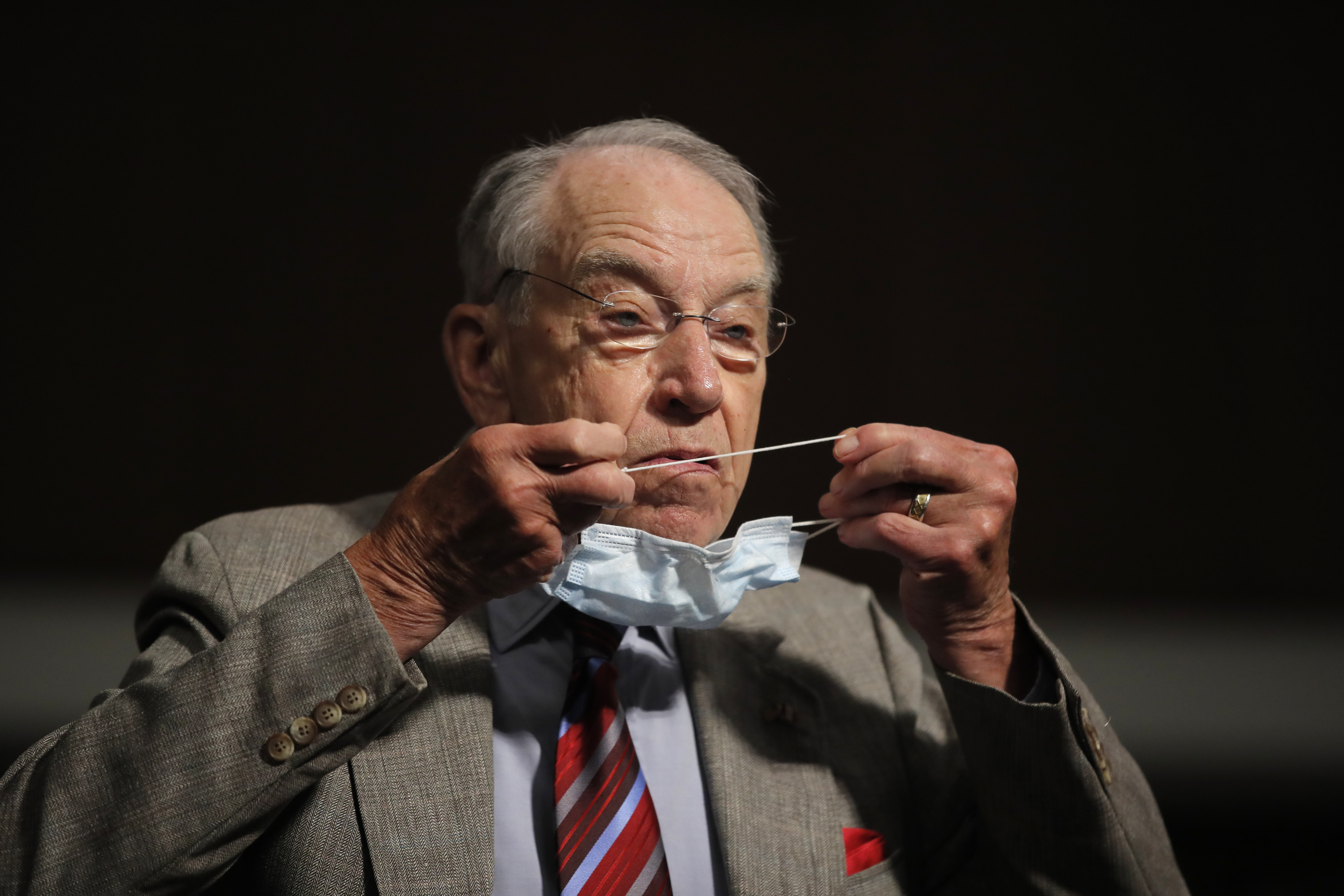 Sen. Chuck Grassley, R-Iowa, puts on a face mask during a Senate Judiciary Committee on Capitol Hill in Washington on June 11, 2020.